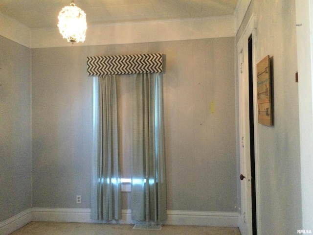 spare room with a notable chandelier