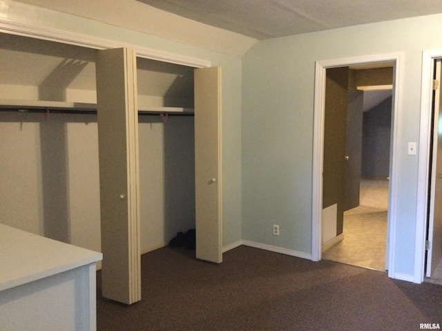 unfurnished bedroom featuring dark colored carpet