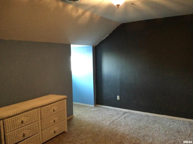 additional living space with carpet flooring and vaulted ceiling