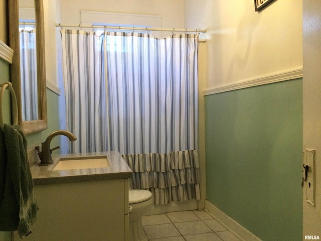 bathroom with tile patterned flooring, vanity, and toilet