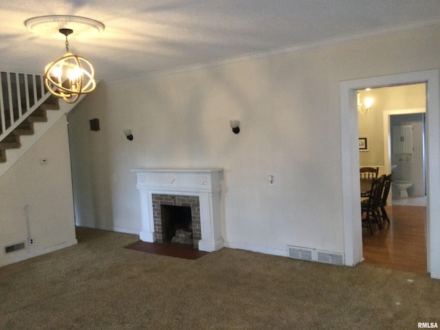 unfurnished living room with carpet flooring, a notable chandelier, crown molding, and a brick fireplace