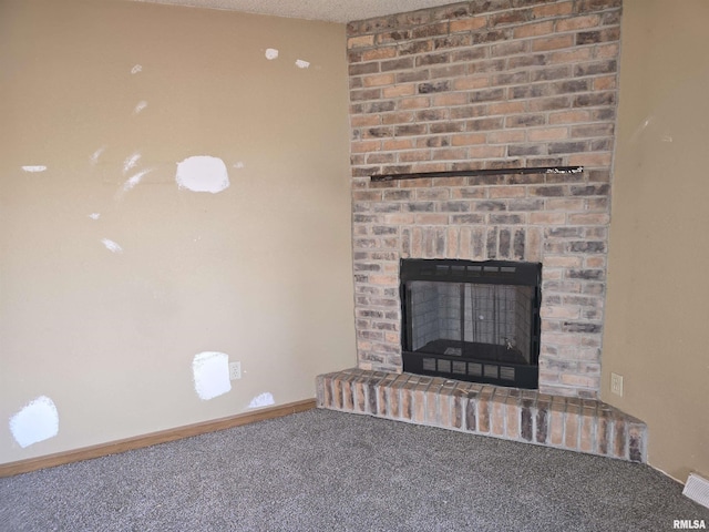 details featuring carpet floors, a brick fireplace, baseboards, and a textured ceiling