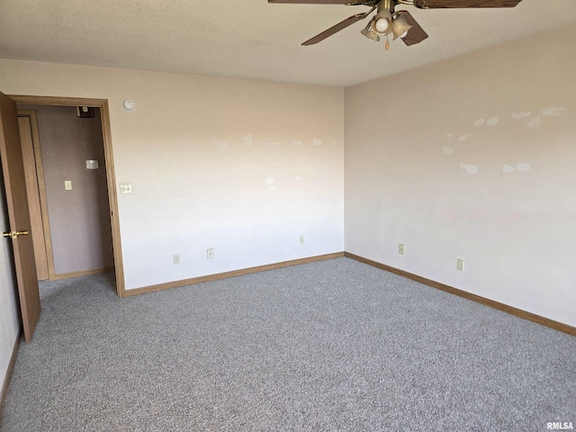 empty room with carpet, a ceiling fan, and baseboards