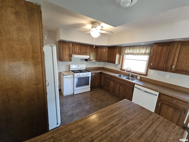 kitchen with white appliances, dark wood-type flooring, sink, ceiling fan, and a textured ceiling