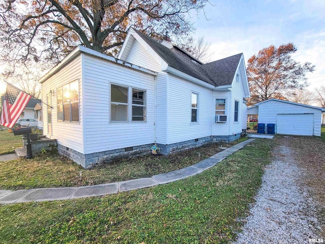 view of property exterior featuring cooling unit, a garage, an outdoor structure, and a yard