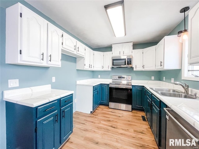 kitchen with light hardwood / wood-style floors, sink, white cabinetry, and stainless steel appliances