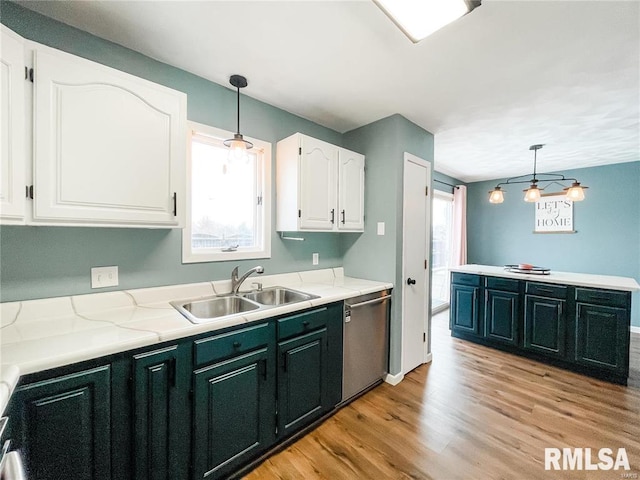 kitchen featuring pendant lighting, dishwasher, sink, and a wealth of natural light