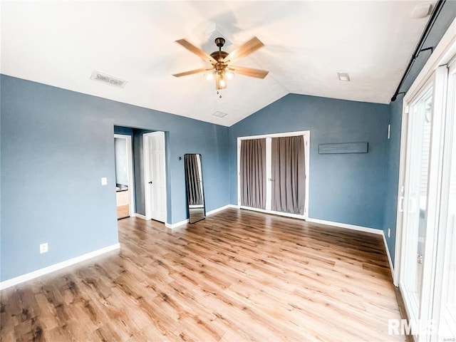 unfurnished bedroom featuring ceiling fan, light hardwood / wood-style floors, and vaulted ceiling