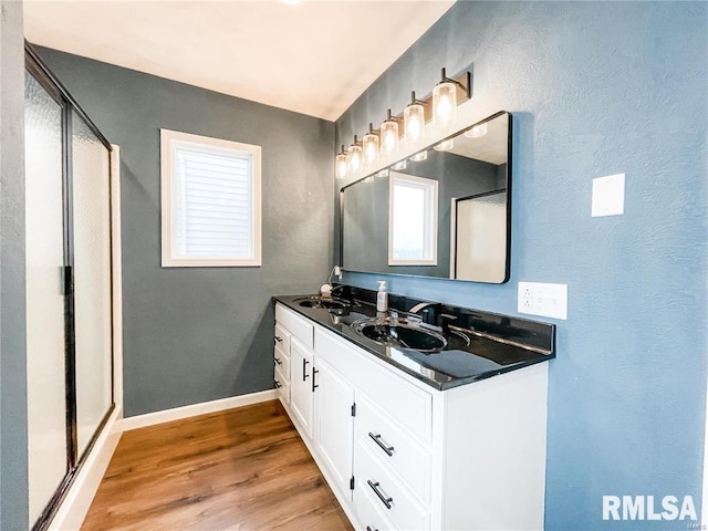 bathroom featuring vanity, hardwood / wood-style flooring, and walk in shower