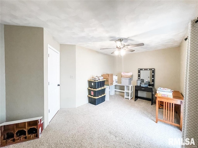 interior space featuring carpet and ceiling fan