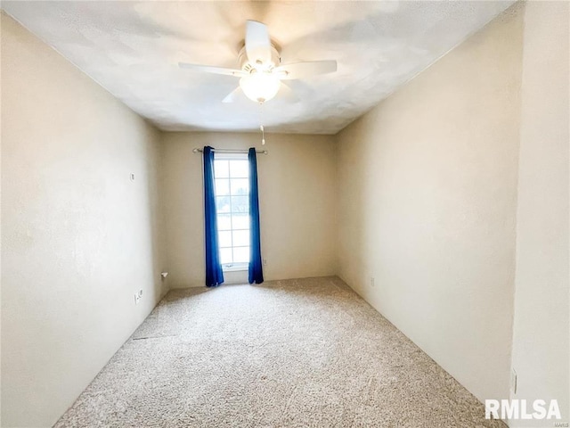 spare room featuring carpet floors and ceiling fan