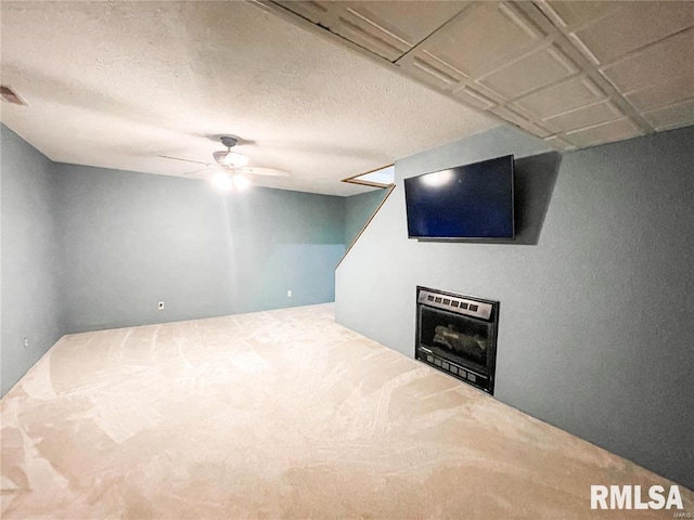 basement featuring carpet, heating unit, and ceiling fan