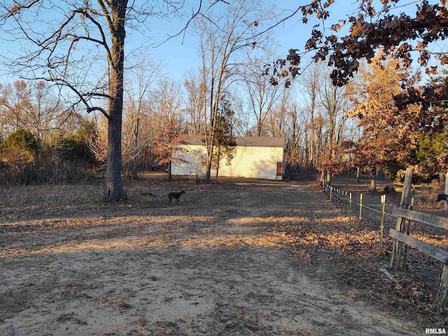 view of yard featuring a rural view and an outdoor structure