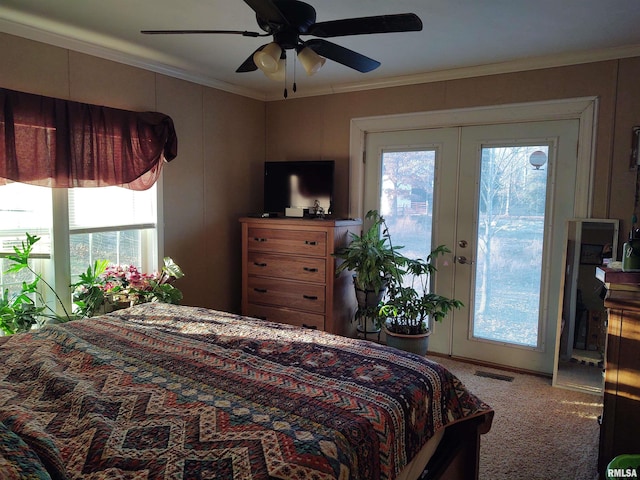 carpeted bedroom featuring french doors, crown molding, ceiling fan, access to exterior, and multiple windows