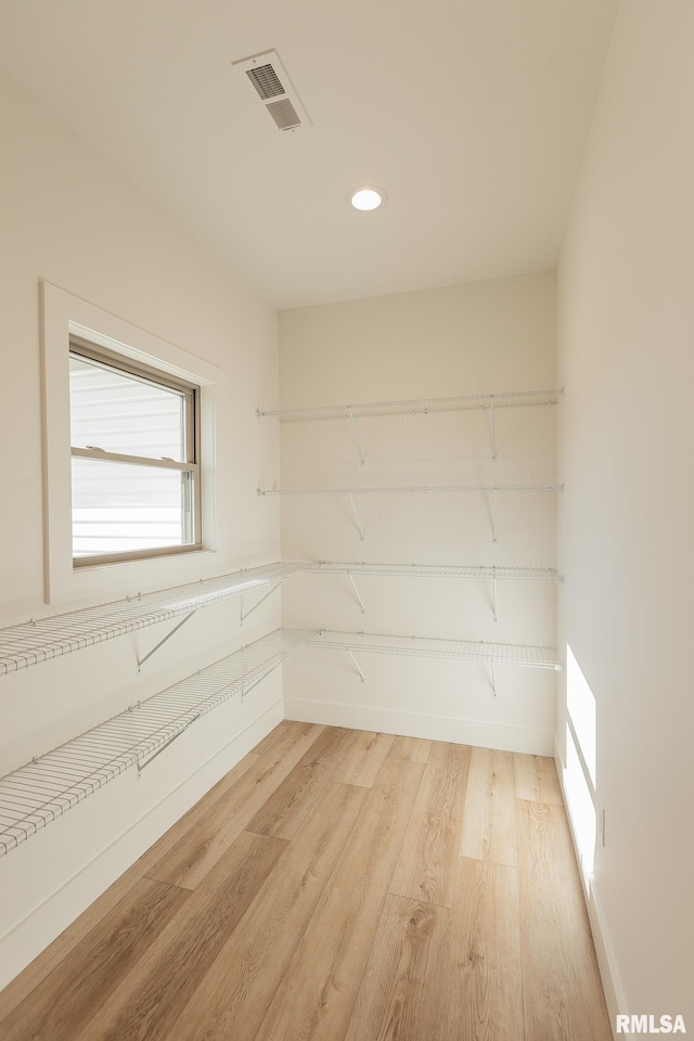 unfurnished room with light wood-type flooring