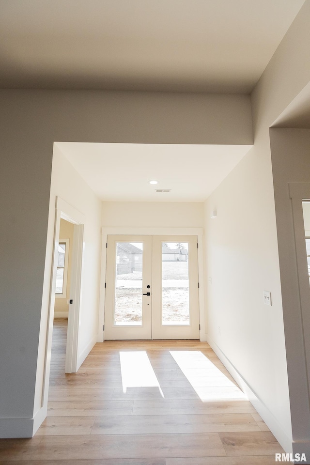 doorway to outside featuring light wood-type flooring and french doors