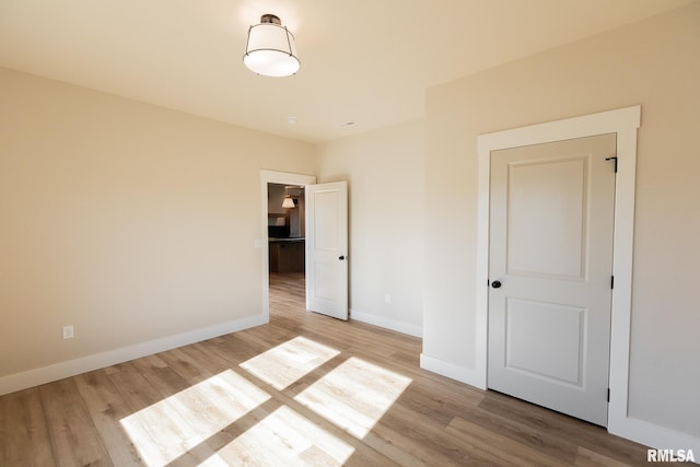 unfurnished bedroom with light wood-type flooring