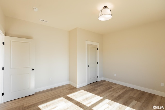 spare room featuring light hardwood / wood-style floors