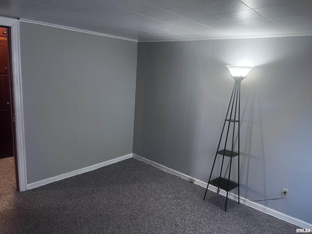 empty room with dark colored carpet and ornamental molding