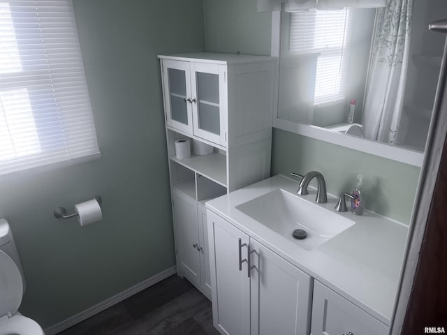 bathroom featuring hardwood / wood-style floors, vanity, and toilet