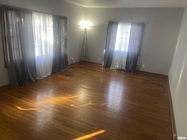 spare room with dark hardwood / wood-style floors