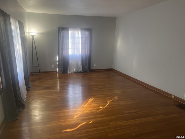 spare room featuring dark hardwood / wood-style floors