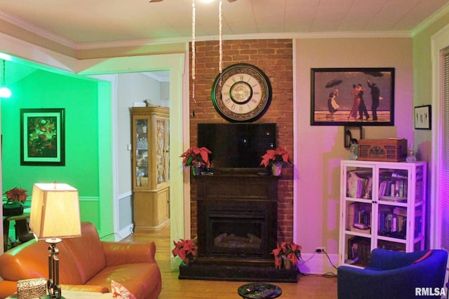 living room with crown molding, a fireplace, and hardwood / wood-style floors