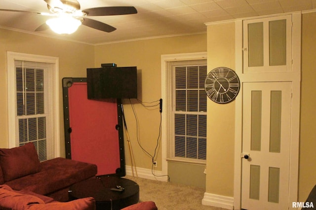 living room featuring ceiling fan, carpet, and ornamental molding