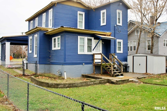 back of house featuring a lawn and a shed