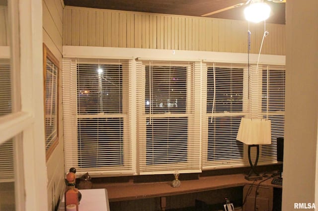 room details with ceiling fan and wood walls