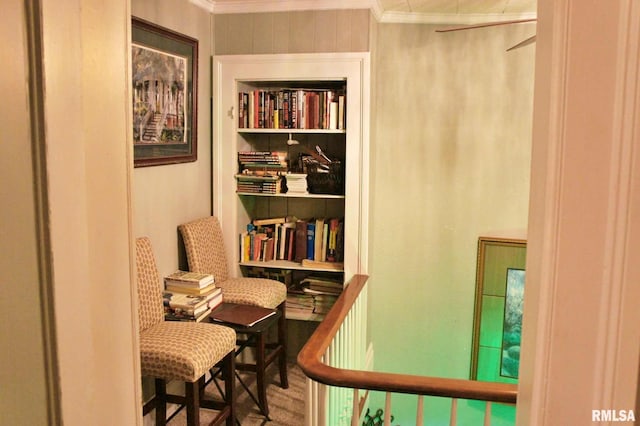 living area with crown molding