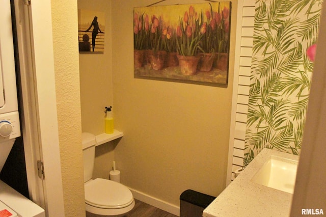 bathroom featuring hardwood / wood-style floors, vanity, and toilet