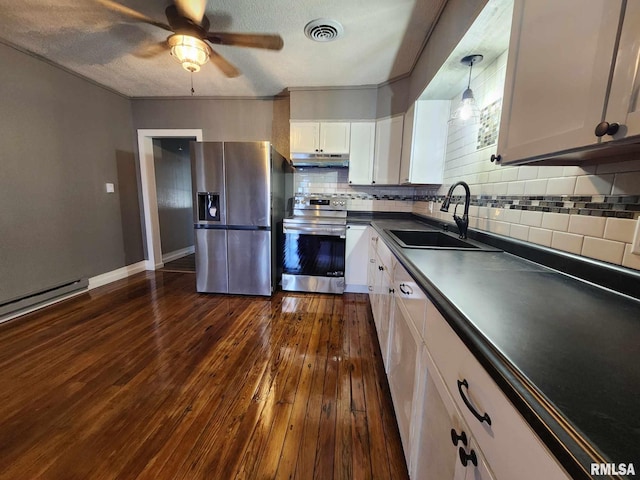 kitchen featuring appliances with stainless steel finishes, dark hardwood / wood-style flooring, sink, pendant lighting, and white cabinetry