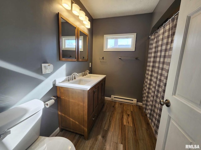 bathroom featuring vanity, hardwood / wood-style flooring, toilet, baseboard heating, and a textured ceiling