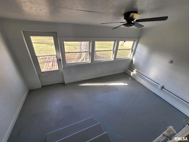 spare room with concrete flooring, ceiling fan, and a healthy amount of sunlight