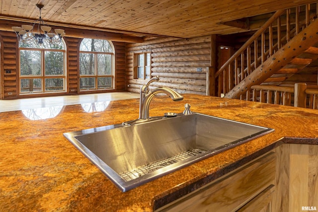 interior details with hanging light fixtures, sink, wooden ceiling, and an inviting chandelier