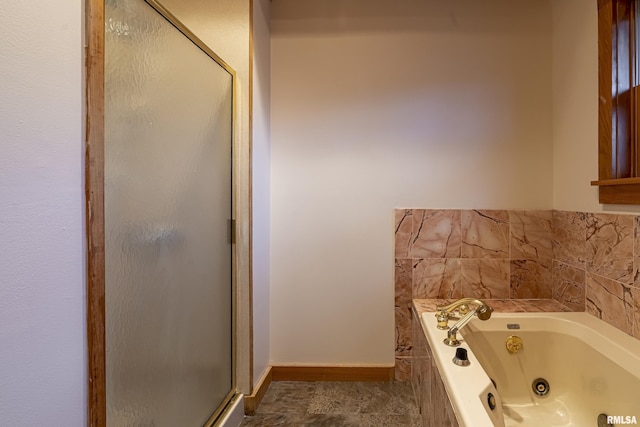 bathroom featuring shower with separate bathtub