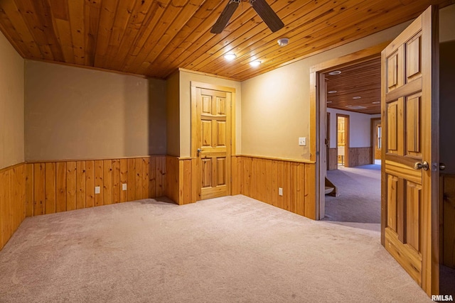 221 Poplar Lake Rd, Makanda, IL 62958 - spare room featuring wainscoting, wood ceiling, carpet floors, wooden walls, and a ceiling fan