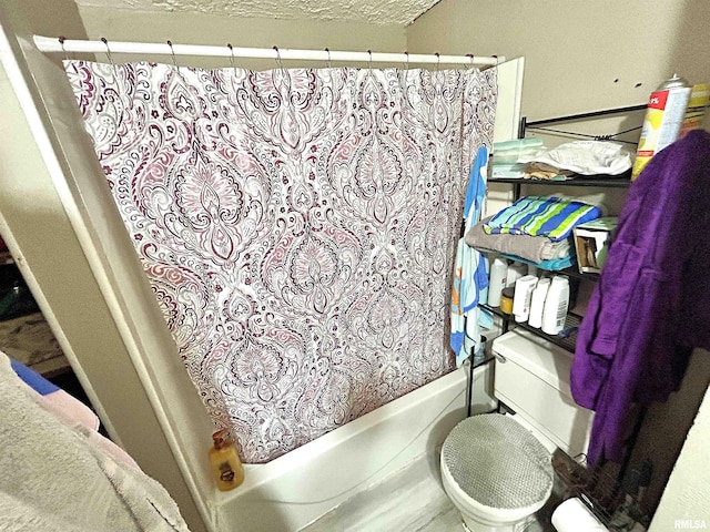 bathroom featuring a textured ceiling and shower / bath combo with shower curtain