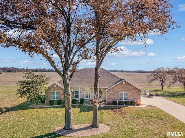 single story home featuring a rural view and a front yard