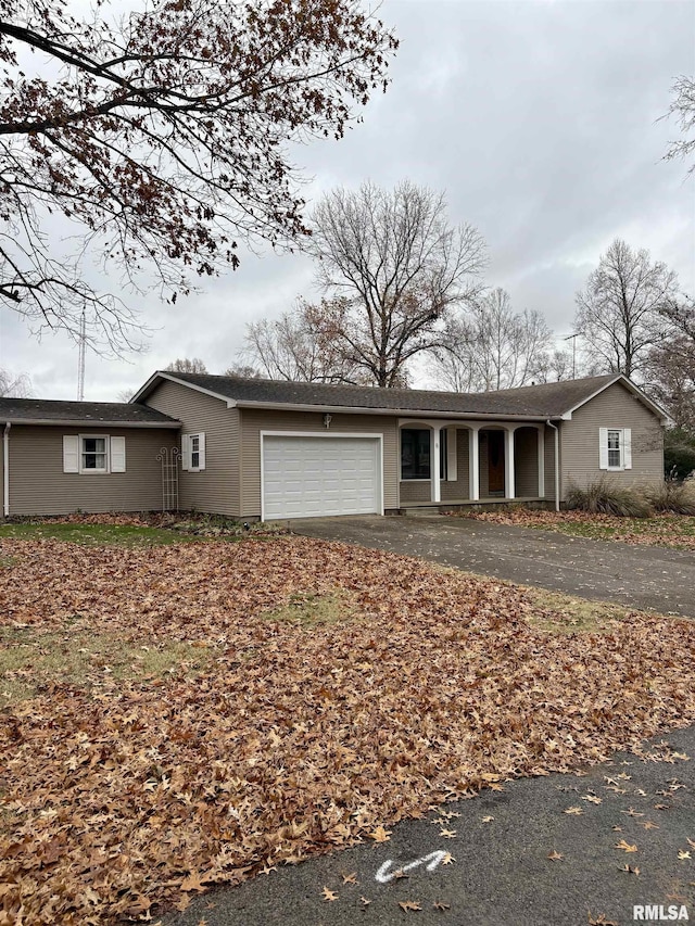 ranch-style house with covered porch and a garage