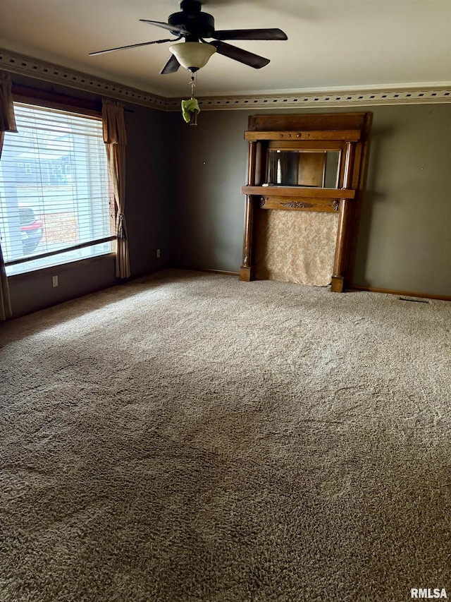 carpeted empty room featuring ceiling fan