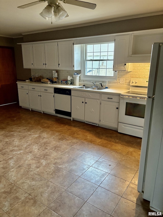 kitchen featuring white cabinetry, white appliances, sink, and tasteful backsplash