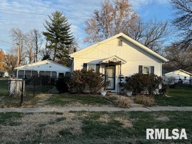 bungalow-style home with a front yard