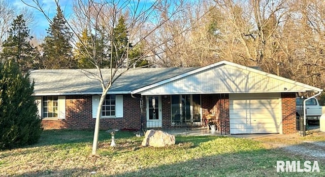 ranch-style home featuring a front lawn and a garage