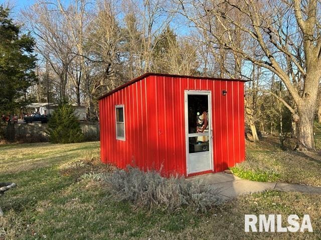 view of outbuilding with a lawn