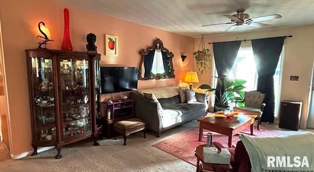 carpeted living room featuring ceiling fan