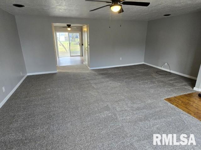 carpeted empty room with a textured ceiling and ceiling fan