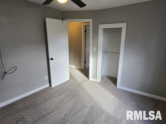 unfurnished bedroom with carpet flooring, ceiling fan, and a closet