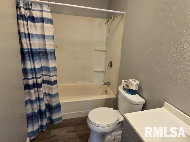 full bathroom with vanity, wood-type flooring, shower / bath combo, and toilet